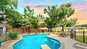 A backyard with a swimming pool, patio furniture, and a fence. - Summer Oasis - Pool and Hot Tub, Private Backyard (Keller)
