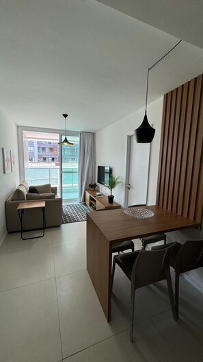 Relax in this stylish living area with a sofa, dining table, and flat-screen TV.