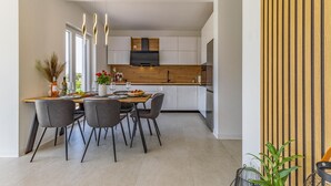 A modern kitchen with white cabinets, a wooden countertop, and a built-in oven. - 2 bedroom gorgeous apartment in Pula (Pula)