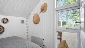 A bedroom with a bed, a radiator, and two wall-mounted fans. - 2 bedroom beautiful home in Børkop (Børkop)
