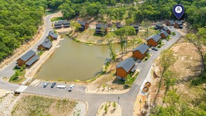 A residential area with houses, a parking lot, and a body of water.
