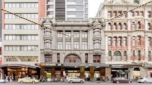 A historic building with a classic architectural style, featuring arched windows and decorative elements.