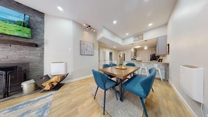 A modern kitchen with white cabinets, a black refrigerator, and a wooden countertop. - Ski-in Ski-out  | Updated | High Ceilings | Gold Creek 204 (Angel Fire)