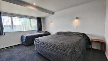 2 habitaciones, escritorio y tabla de planchar con plancha