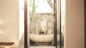 A narrow hallway leading to a bathroom with a bathtub, a small window, and a door. - Villa Puri Kembar – A Serene Escape with a Private Pool & Stunning Views (Bali)