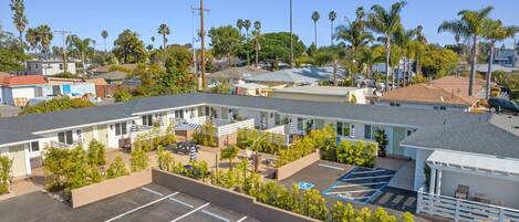 A motel with multiple rooms, a parking lot, and a small pool area.