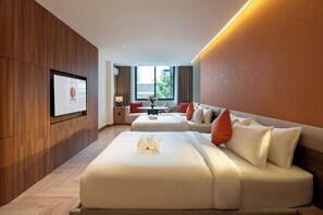 A modern hotel room with a large bed, a sofa, a dining table, and a TV mounted on the wall. - Metrolux City Contemporary Hotel (Ho Chi Minh City)
