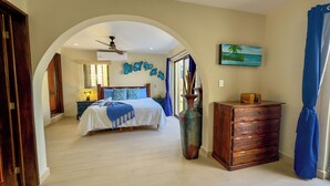 A bedroom with a bed, a dresser, a vase, and a painting on the wall.