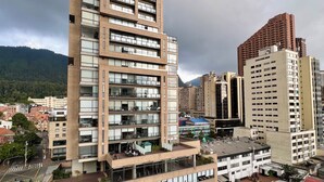 A high-rise building with multiple balconies and a rooftop garden. - Welcome to your perfect getaway in the heart of Bogota (Bogotá)