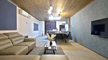 Relax in this stylish living room with a sofa, coffee table, and flat-screen TV.