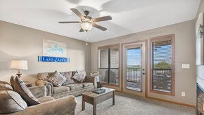 A living room with a ceiling fan, a sofa set, a coffee table, and a large window with blinds. - 2BD, Sleeps 8 Lake Condo, Resort Perks, Ticket/Golf Deals (Branson)