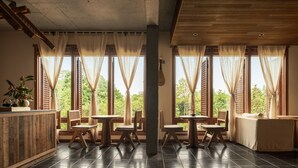 A room with large windows, wooden furniture, and a tiled floor. - Hegu Mountain Retreat (Chengdu)