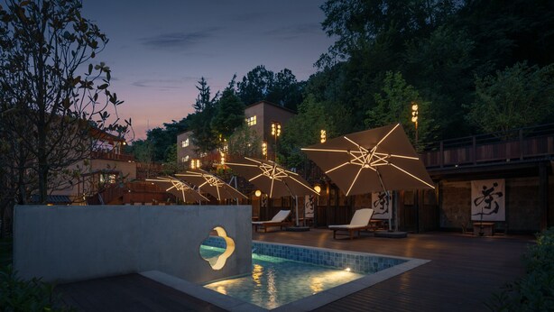 A pool area with lounge chairs and geometric light fixtures. - Hegu Mountain Retreat (Chengdu)