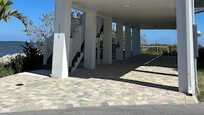 A two-story house with a covered porch and a view of the ocean. - New Waterfront❗️Pool, Epic Views/Corner Lot❤️Beaches near~BBQ Grill~Washer/Dryer (Jensen Beach)
