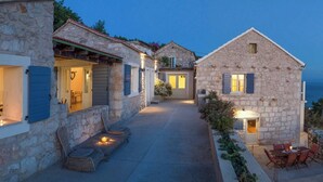 A stone building with a covered patio and outdoor seating area. - Luxury Villa in Zavala w/pool (Zavala, Jelsa)