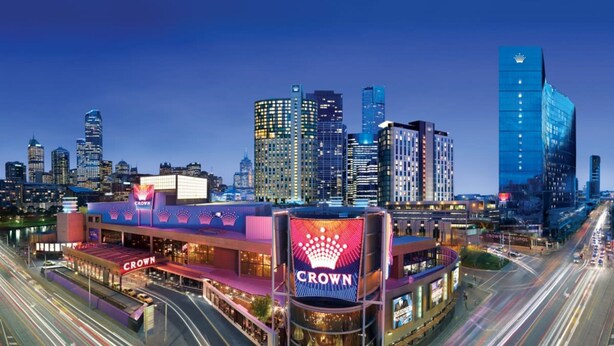 A hotel with a prominent 'Crown' sign, surrounded by a city skyline with modern buildings. - Vista on Queensbridge - 3BR Home in the Heart of It All (Southbank)