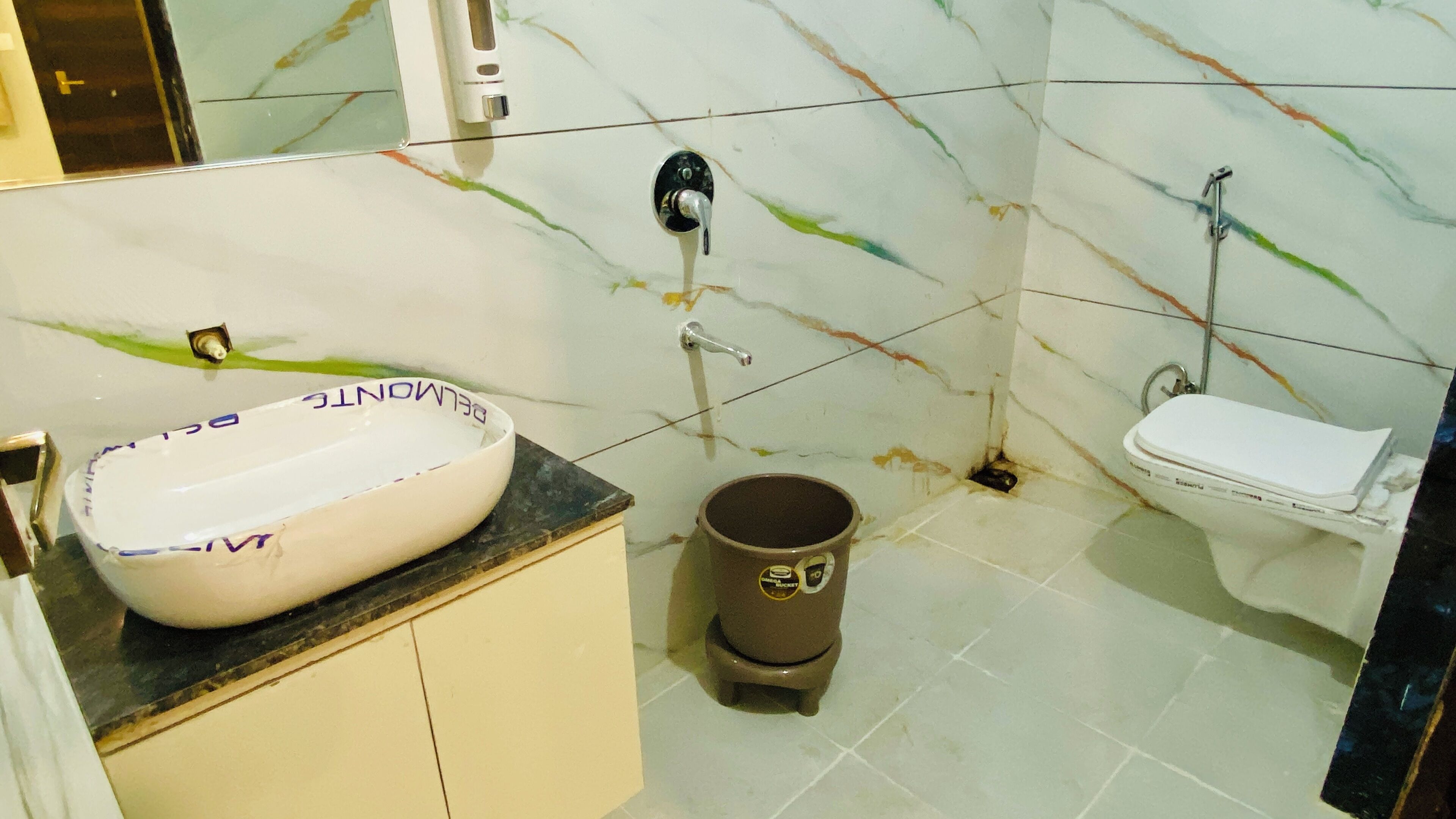 Un bagno con lavandino bianco, water e doccia.