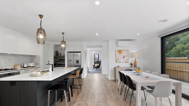 A modern kitchen with a central island, stainless steel appliances, and pendant lighting. - Adelphi Family Home Near Queenscliff Ferry 10 Min (Point Lonsdale)