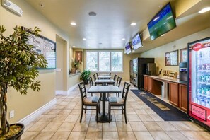 A restaurant with tables and chairs, a Coca-Cola refrigerator, and a TV on the wall. - South Reno 1BR · Hot Tub, Mountain Views & Pool (Reno)