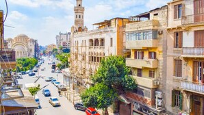 A street view with buildings, a mosque, and a minaret. - Chic 2-bedroom Apartment in Heliopolis (Cairo Governorate)