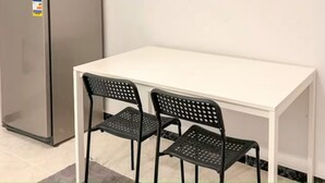 A small room with a white table and two black chairs. - Chic 2-bedroom Apartment in Heliopolis (Cairo Governorate)