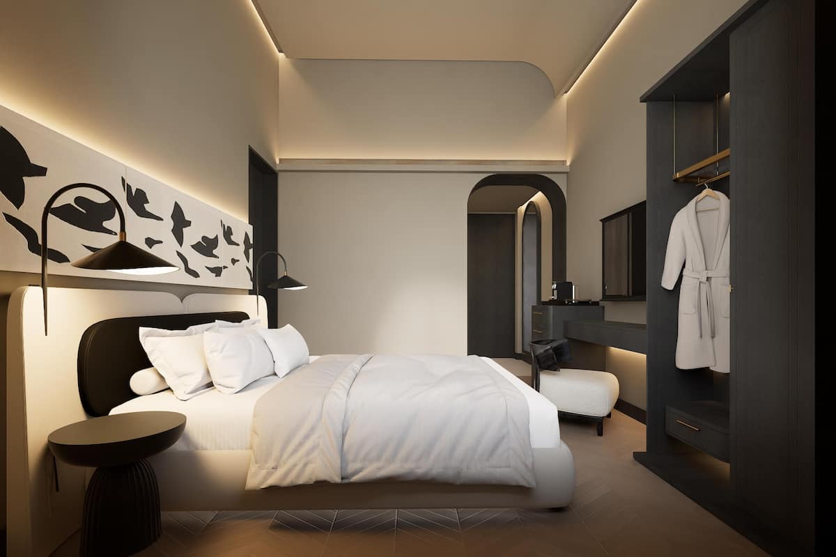 A modern bedroom with a bed, bedside tables, a mirror, and a wardrobe.
