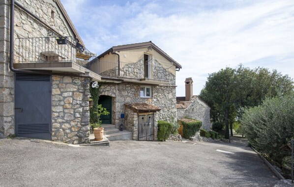 Experience the charm of a traditional building with a balcony and cozy porch area.