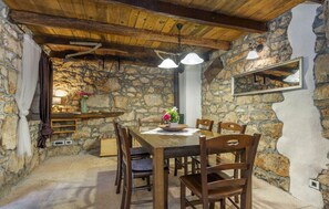 Enjoy meals in this cozy dining area with a wooden table and comfortable chairs.