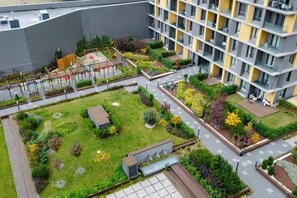 An aerial view of a residential complex with multiple apartment buildings, a central courtyard with greenery, and a playground. - lUX Residence on High Floor 03 (Istanbul)