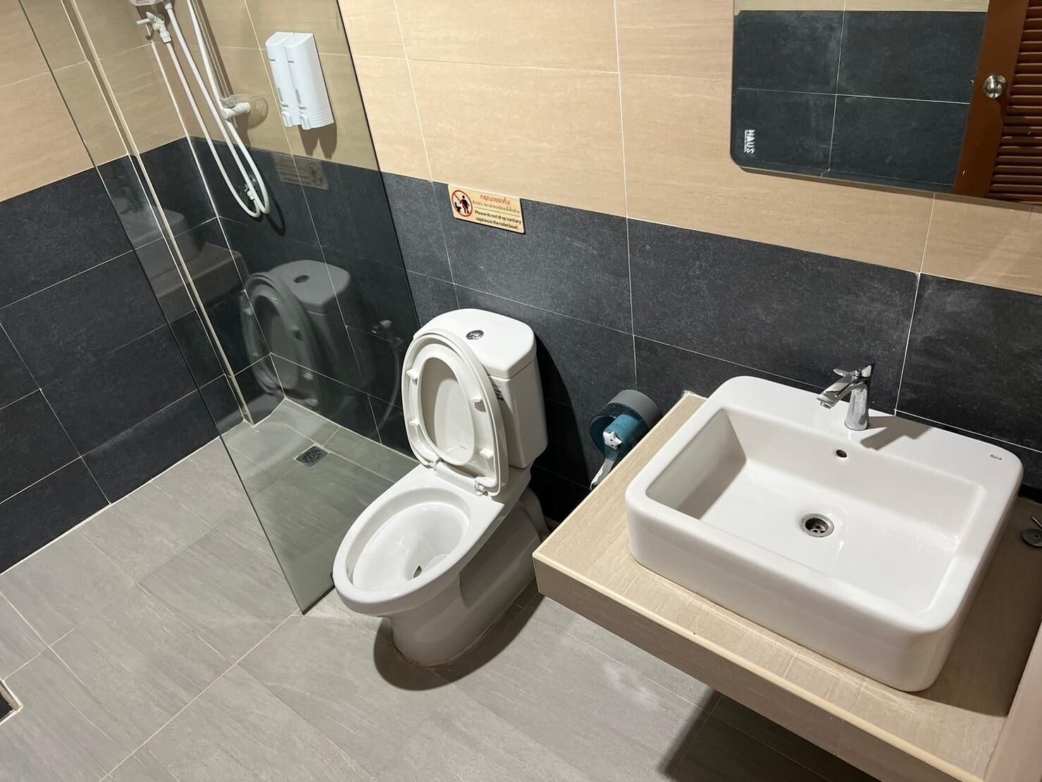 A modern bathroom with a toilet, bidet, and sink.