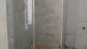 A shower enclosure with tiled walls and a glass door. - 0688429688 Guesthouse in Mafikeng  (Mahikeng)