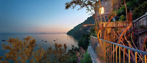A coastal view with a wooden staircase leading down to a beach.