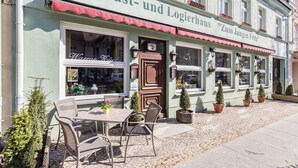 Ein Gast- und Logierhaus mit Außenbereich, einer Tür und Topfpflanzen.