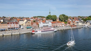 Een rivier met een boot en een zeilboot.
