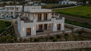 A modern two-story house with a flat roof, large windows, and a balcony. - Cozy Haven -island Living Paros (Paros)