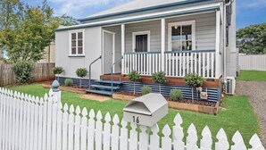 A single-story house with a porch, a mailbox, and a small garden. - Eton Cottage: Central Boutique Stay (East Toowoomba)