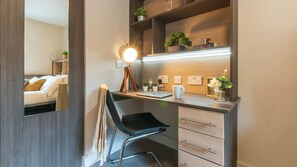 A modern bedroom with a bed, a chair, a desk, and a mirror. - Oxford Court (Manchester)
