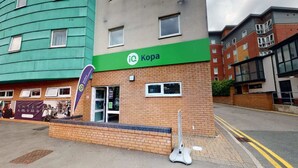 A building with a green sign reading "Kopa" and a reception area. - Student Only Kopa (Preston)
