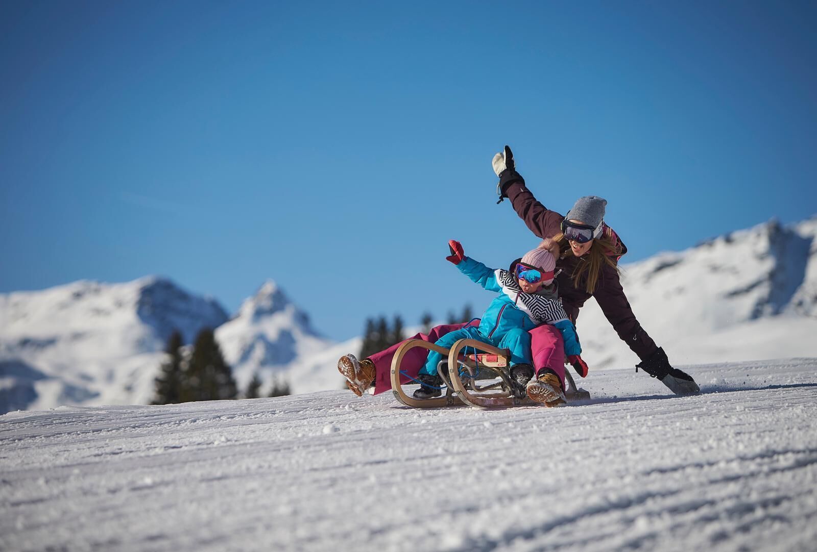A snowy landscape with a sledding activity.