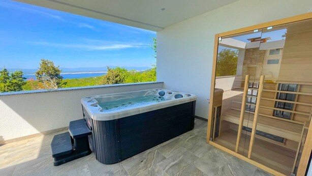 A modern bathroom with a hot tub, a glass shower enclosure, and a view of the sea. - Villa Linda 2 (Crikvenica)