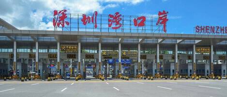 A customs checkpoint with multiple lanes and signage indicating 'China Customs'.