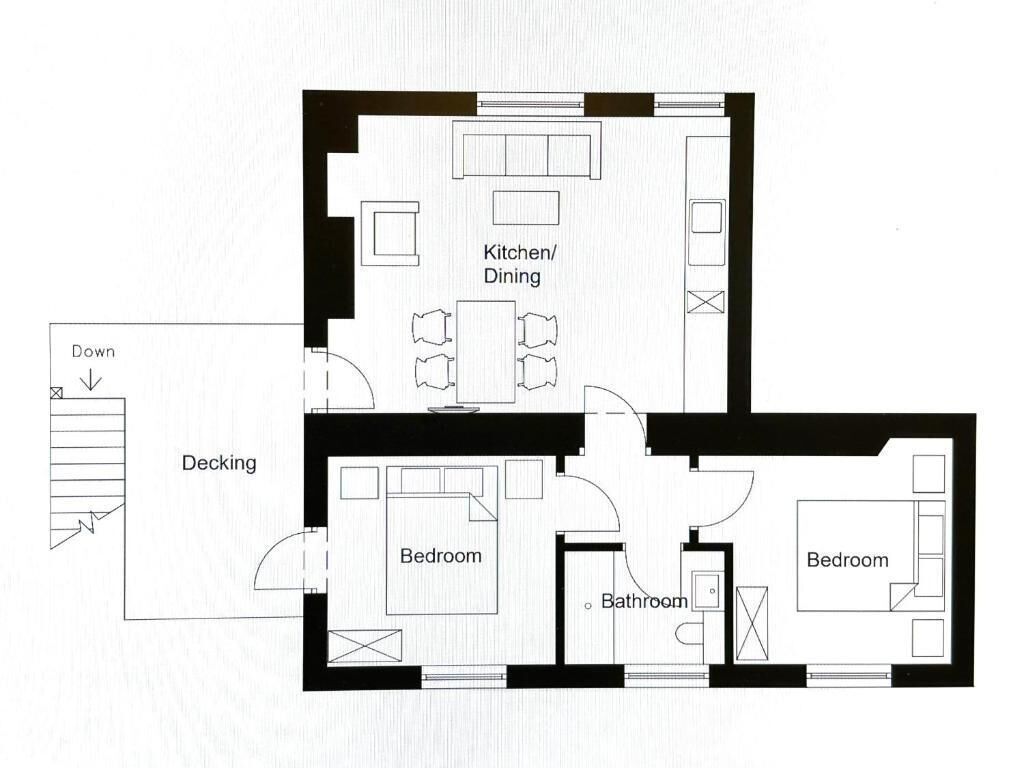 A floor plan with a kitchen/dining area, two bedrooms, a bathroom, and a deck.