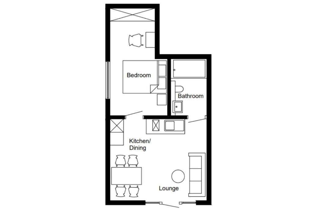A floor plan with a bedroom, bathroom, kitchen/dining, and lounge area.
