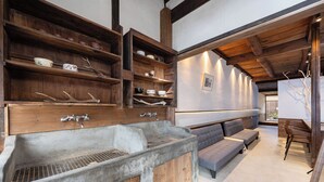 A modern kitchen with wooden shelves, a concrete sink, and a built-in bench. - Mameyama15 (Nara)