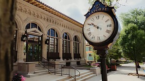 A historic building with arched windows and a clock.