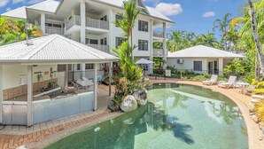 A resort with a pool, multiple balconies, and outdoor seating areas.