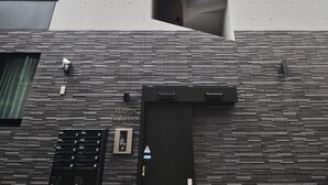 A modern building with a unique architectural design, featuring a series of protruding balconies and a textured facade. - RIZOTIA HAKUSAN by Tranova (Tokyo)