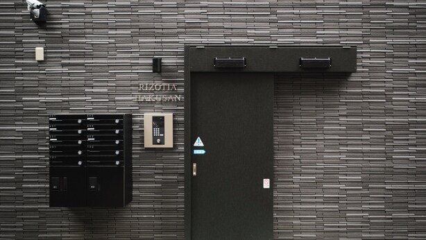 A modern elevator with a digital display, a keypad, and a sign indicating a fire exit. - RIZOTIA HAKUSAN by Tranova (Tokyo)