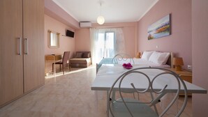 A hotel room with a bed, a desk, a chair, a dining table, and a wardrobe. - Ionian View Gem - Parga Charming Nest (Parga)