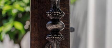 A wooden door with a decorative metal handle.